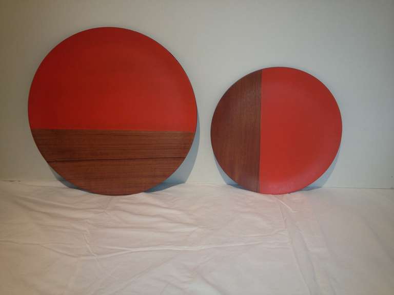 Pair Large serving platters/wall hanging Chargers in walnut wood and orange painted.possibly Japanese with black backs .one charger is 18' and the smaller one is 14