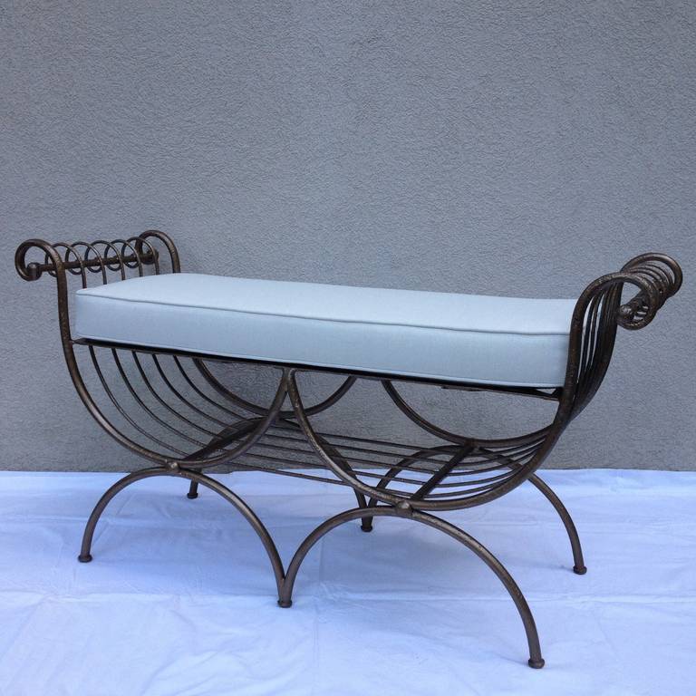 Pair hand wrought Hollywood Regency Iron curled Arm Benches in a Bronze gilt finish,with a long pair off white cushions.