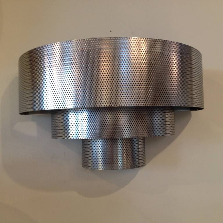 Art Deco skyscraper polished steel sconces, three-tier design. With perforated small dots throughout design to let the light glow up down and eliminate.