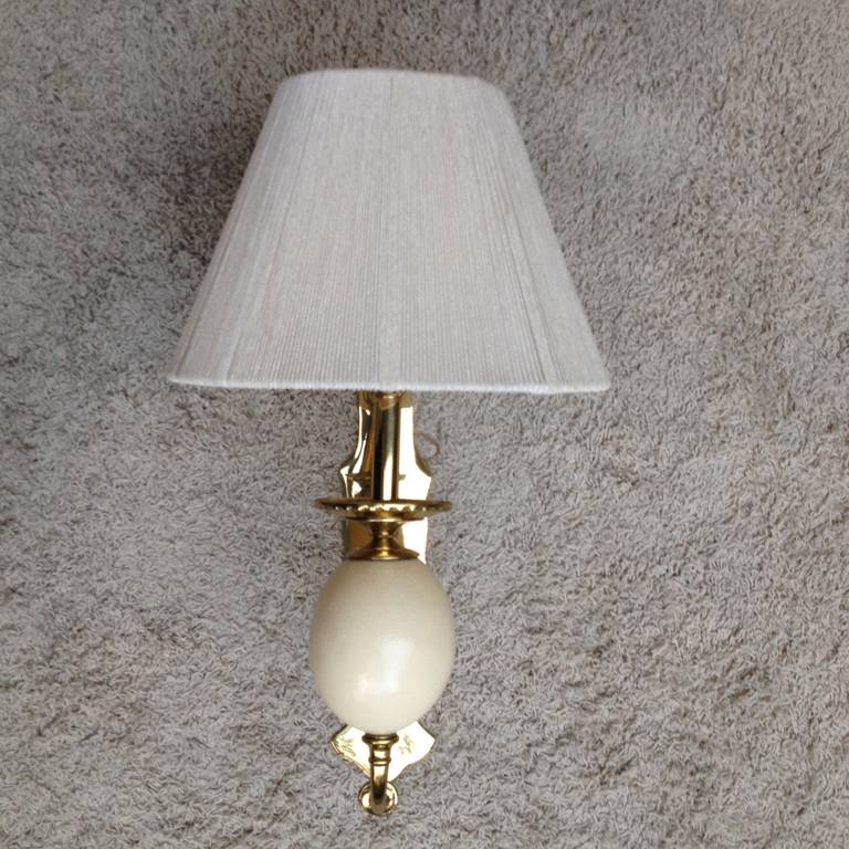Pair of brass and ostrich egg large Hollywood Regency style sconces.