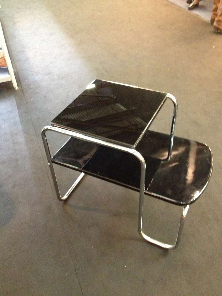 Circa 1930's Art Deco  two tier Tubular chrome Black lacquer end Tables  
the size s are 17.50 wide top shelf 14.75 
bottom 28 x 17.50