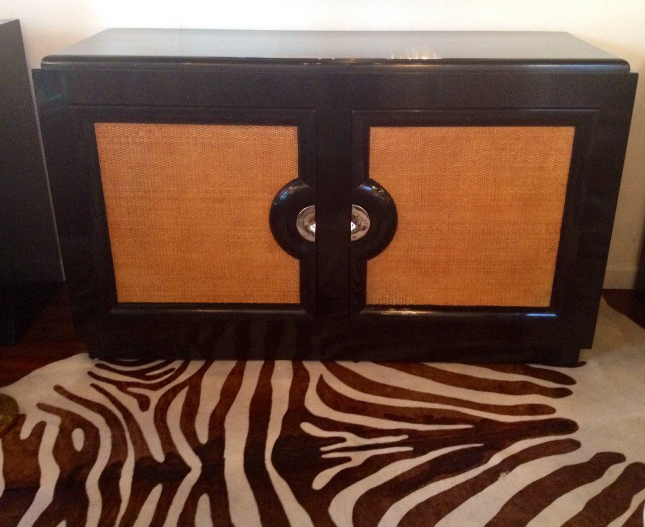 Paul Laszlo cane front small-scale sideboard in black lacquer with nickel polish.
She'd pulls.