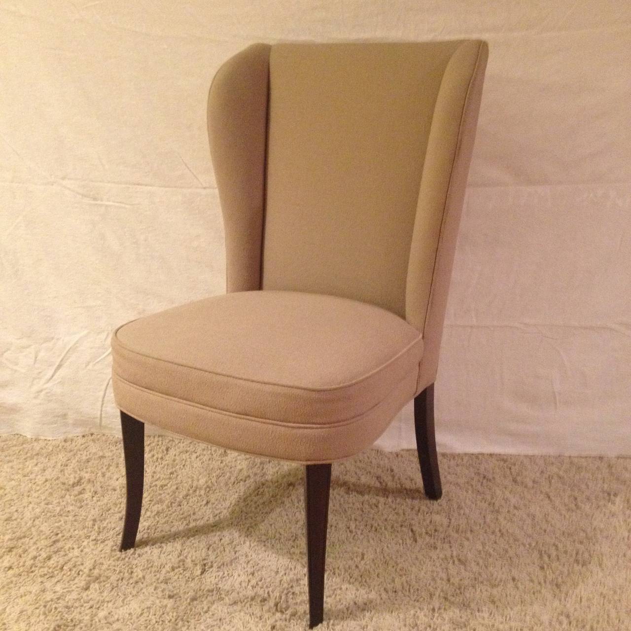 Pair of Parzinger style tall back chairs, with a beige nub fabric and with mahogany legs.