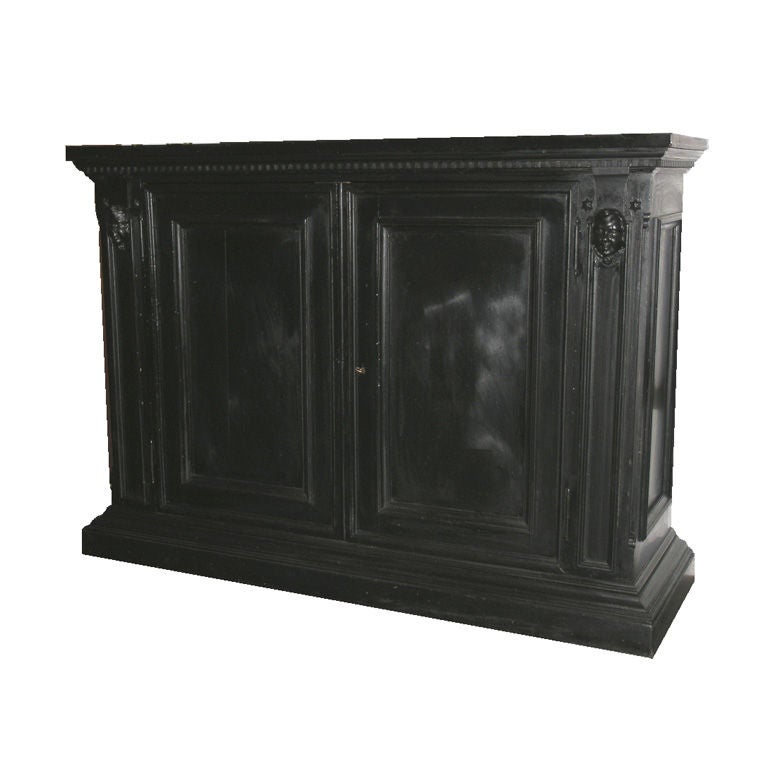 Tuscan ebonized credenza, rectangular top with moulded edge above a pair of paneled doors raised on stepped plinth base.