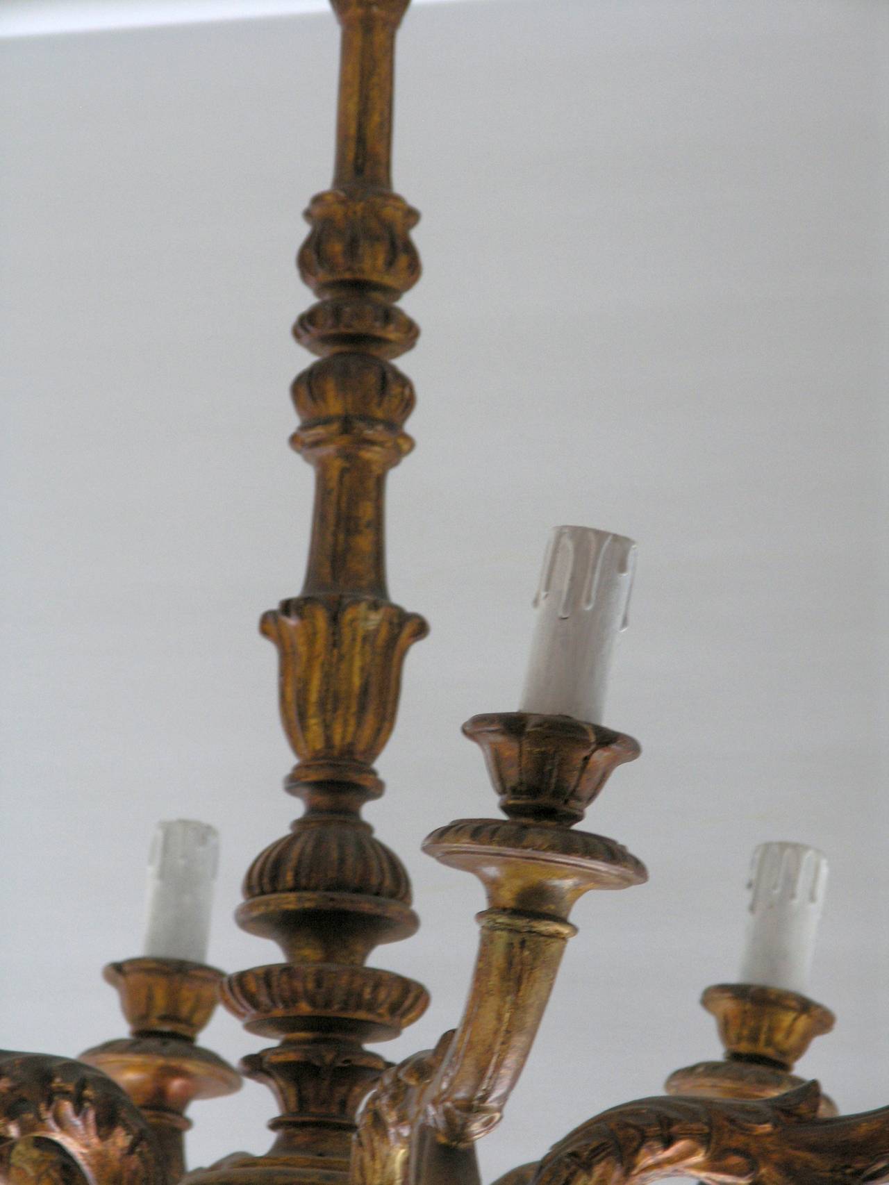Turned vasiform fluted standard issuing a six-leaf carved candle arms with waisted above a lobed pendant.
