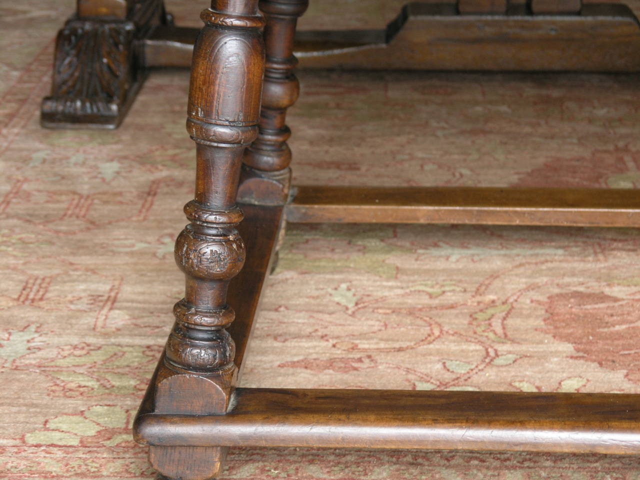 Rectangular top with molded edge above a drawer raised baluster splayed legs joined by stretchers and ending in bun feet