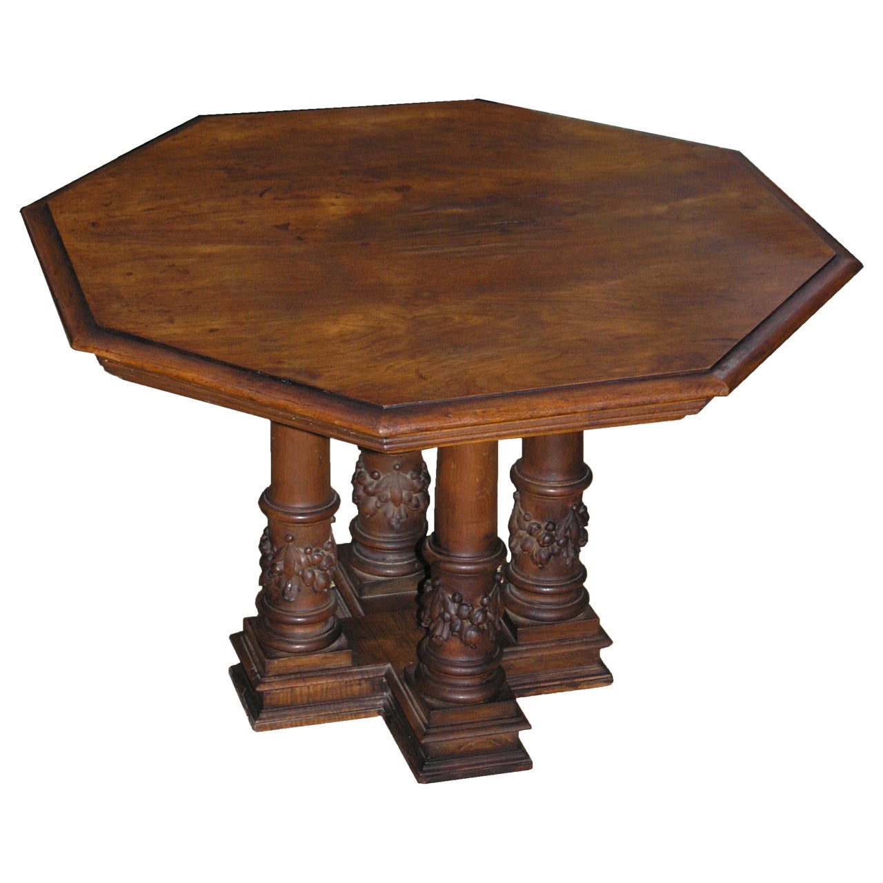 The octagonal top with molded edge on four columnar supports on a cruciform base.