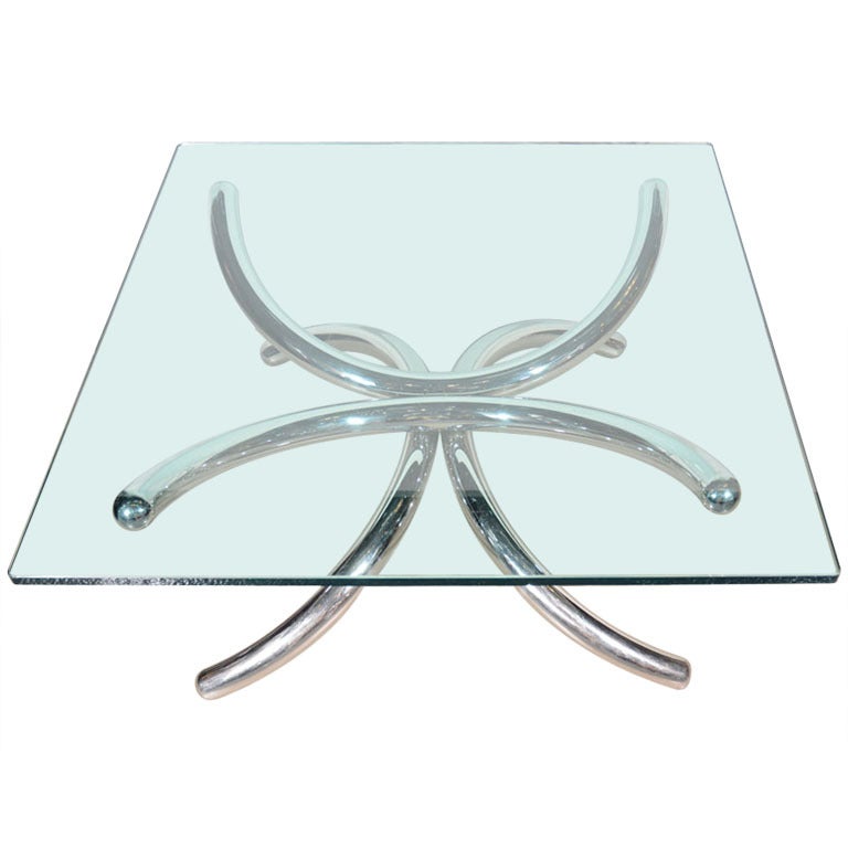 Italian mid-century modern cocktail table with architectural tubular base design.  Artist sculpted design in chrome polished steel, featuring square glass table top. Unusual and beautiful from all angles. 

 
