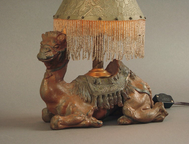 Those King Tut or Egyptian-obsessed of you will adore this camel lamp.  Or, perhaps you just like the smelly, noisy and cantankerous beasts themselves.  

This one started life as an inkwell.  During the Tutomania years a huge desk set was created