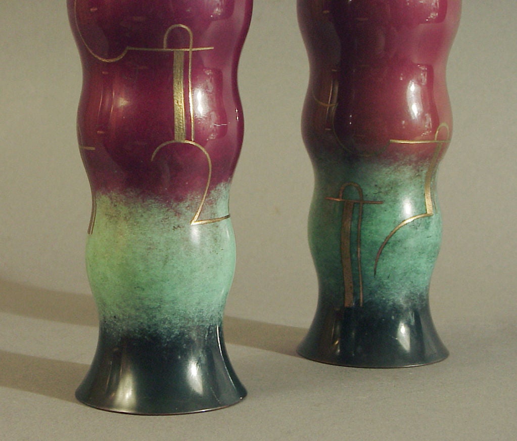 Offering a pair of svelte Modernist vases by the notable German manufacturer WMF, their Ikora line (so marked on their bottoms, see image #3).  The flaring rim at the top of their undulating, tapering bodies seems a logical and elegant design