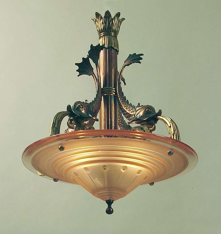 Dolphins are allowed to play in my house, what about you?! This (yes, I'll say it!) EXTRAORDINARY light fixture is made of solid brass; some parts are copper-plated and artfully patinated. It's about 17 inches across and it hangs down about 21
