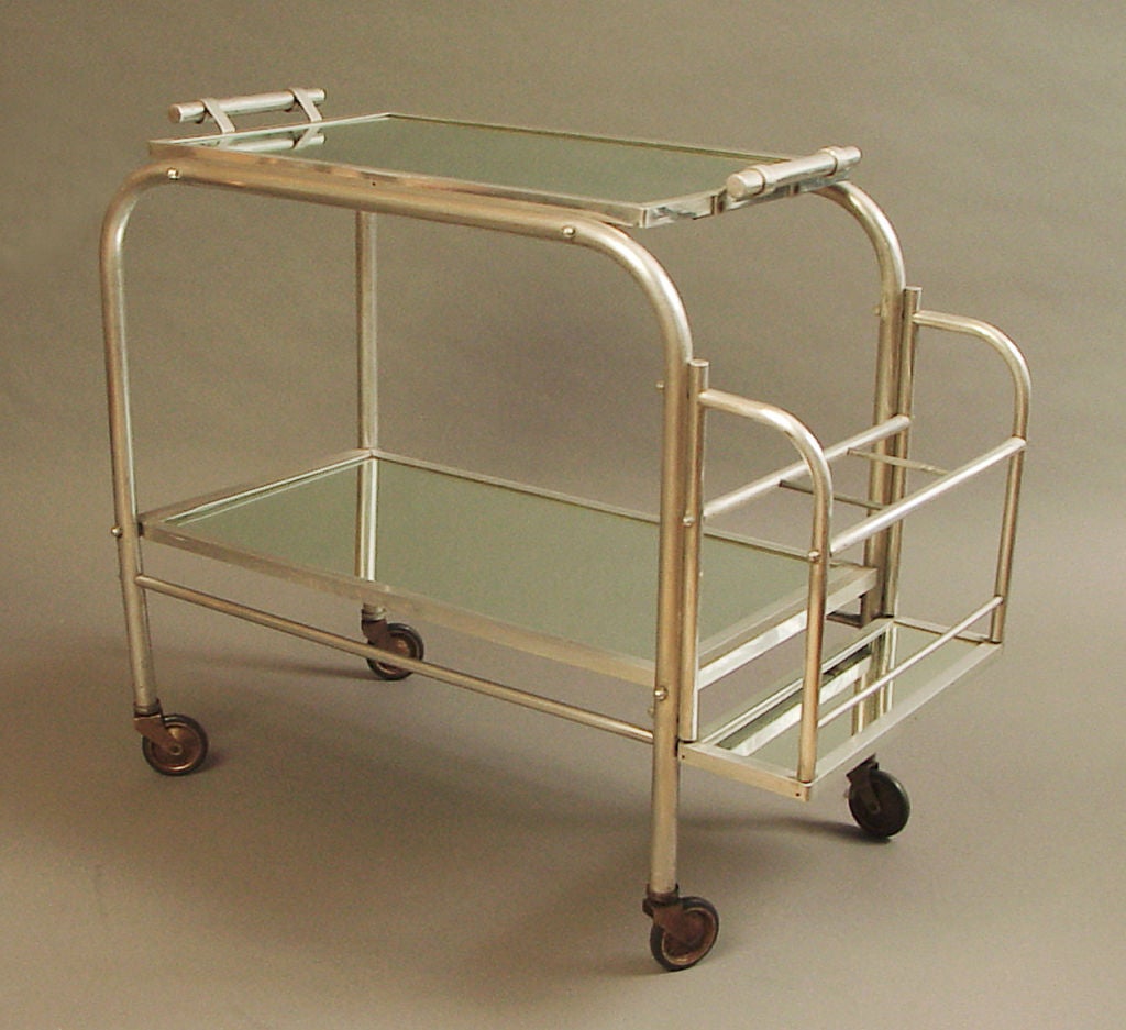 The French made some pretty cool furniture out of solid aluminum tubing, and this is one fine example.  Ever-practical, they designed the tray to lift right off the top so that  drinks can be served to the various guests around the room.  This cart 