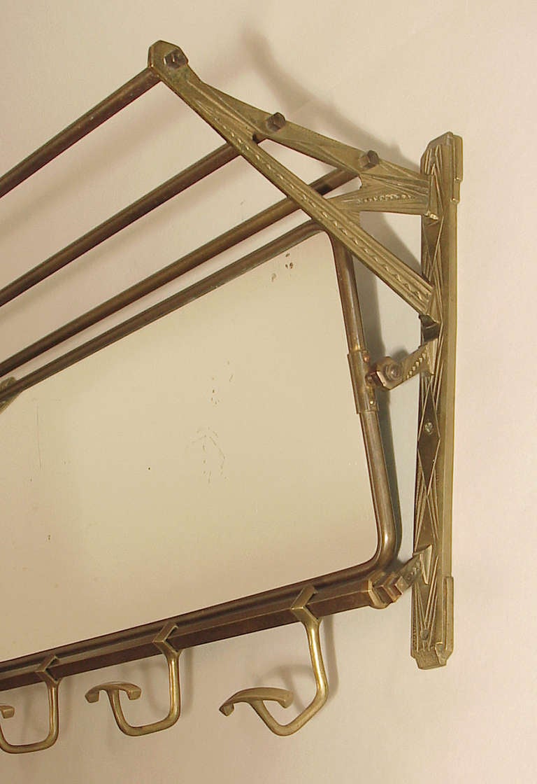 Ready to get those coats off the doorknobs?  Hang this in your entryway and be done with it!  

Solid brass, a rarity in the realm of these French coat racks, and wonderfully decorated with classic Art Deco geometric motifs.  The hooks slide along