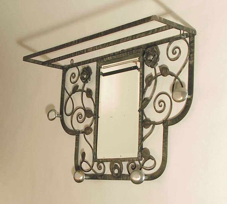 Here's a very decorative and substantial hall tree for your entryway with four chromed hooks (testifying to the Art Deco wthin!!).  Excellent iron-work throughout, with a slightly nickel-like antique patina.  Coat racks of this nature can be a boon