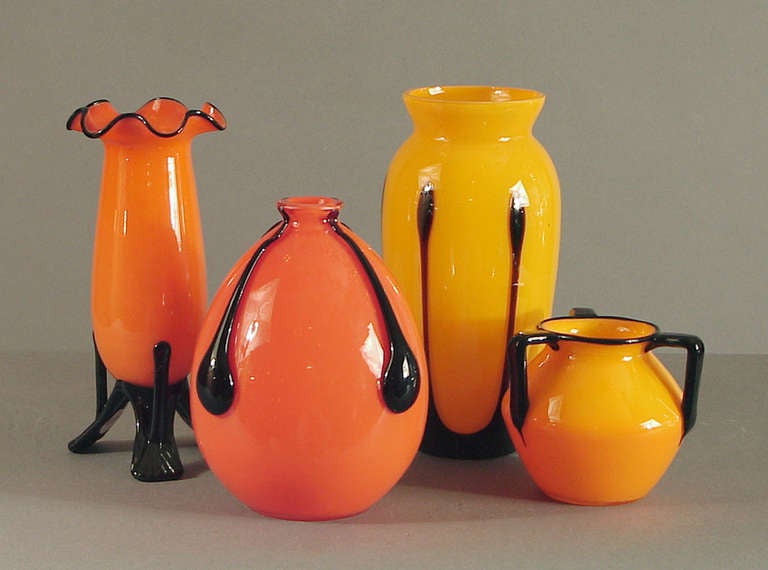 Four striking Art Deco designs by the design genius Michael Powolny, in classically vibrant colors of orange, yellow and black.  The two taller vases are eight inches tall; the ovoid vase is 6 1/4 tall  and the 