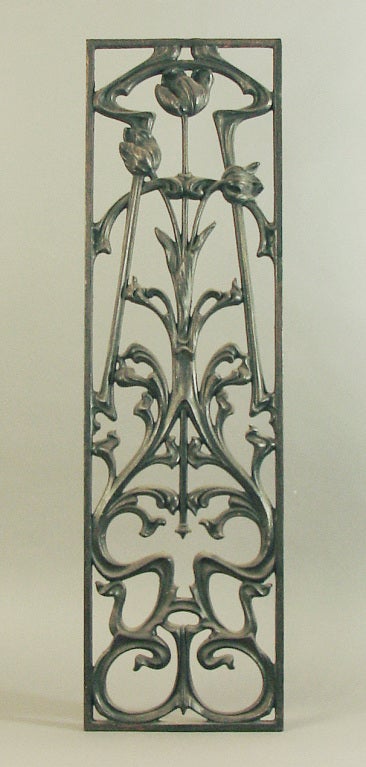 This Art Nouveau grill typifies the higher level of the stylization of the Period.  And, beyond its artistic panache, it has the practical aspect of being able be used to cover a thin window or the window of a door, as probably intended.  Or, just