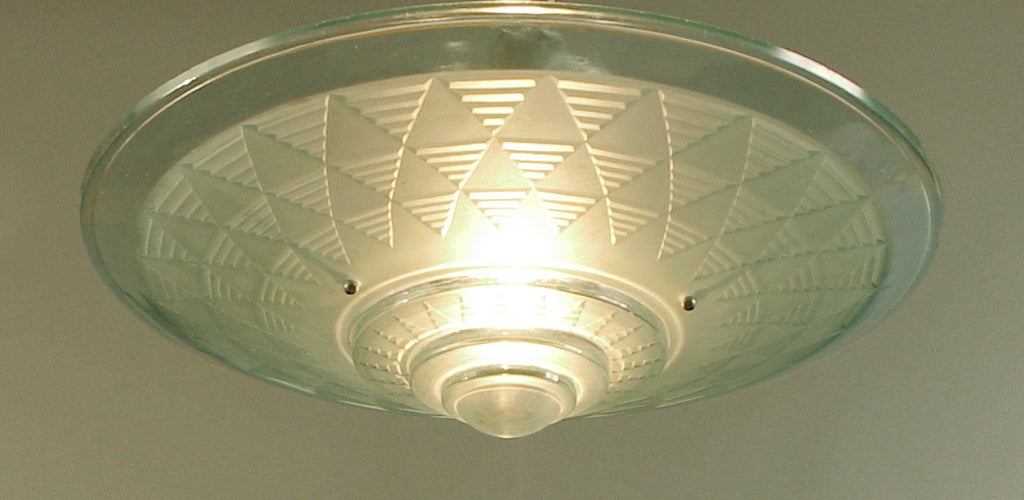 This special ceiling light has several things going for it, among them the Petitot signature (on the rim inside, molded in the glass), a faint blue color, an especially large size (17 1/2 inches in diameter), a riot of geometry.  As shown, it has a