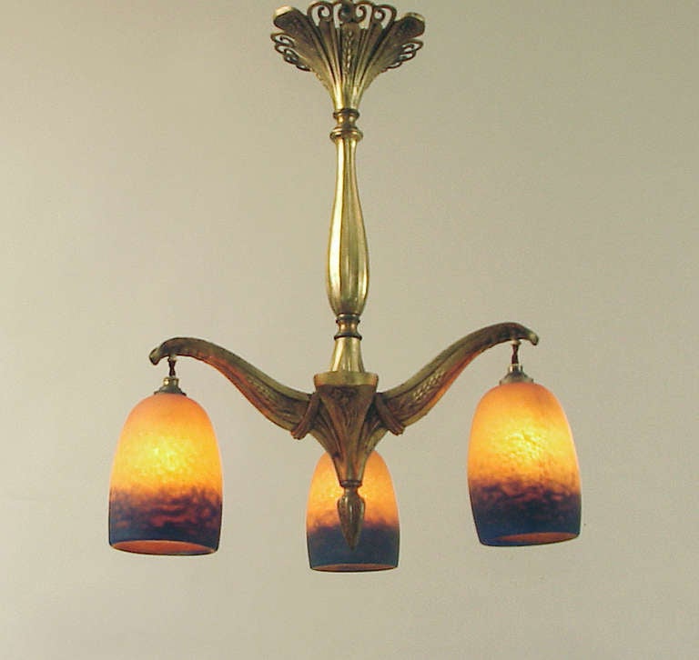 Having both geometric Art Deco motifs as well as organic, Art Nouveau curves, this fixture might be thought of as 