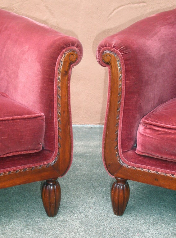 Offering a pair of graceful and elegant French Art Deco wrap-around club or armchairs purchased in Cavaillon, near Avignon.

These chairs have webbing under the stuffed cushions, which is to say, as was originally designed and intended, they have