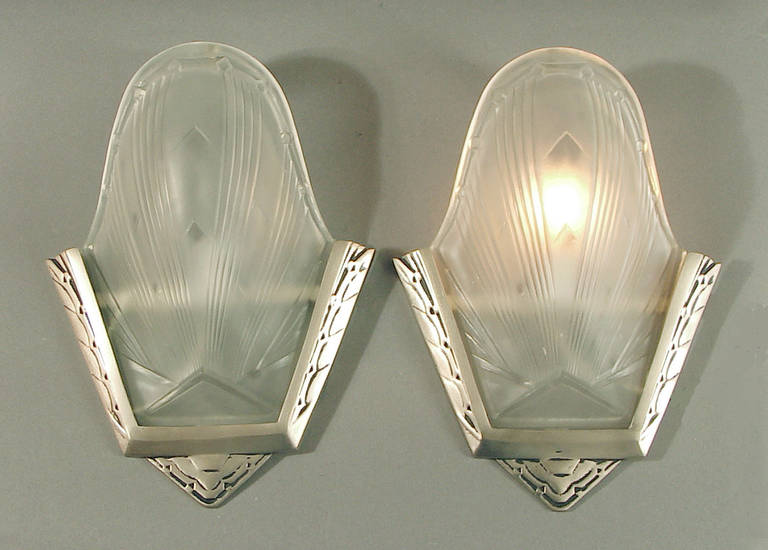 Although this listing is for only a pair, I actually have a matching set of four of these svelte sconces by Des Hanots (unsigned but known to be Des Hanots).  I have taken them entirely apart and had the back plates re-plated in my favorite finish,