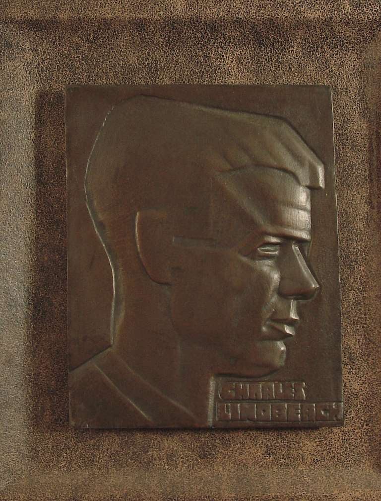 This bronze plaque, highly stylized in the Art Deco manner, depicts one of the icons and heroes of the period, Charles Lindbergh; there's a 