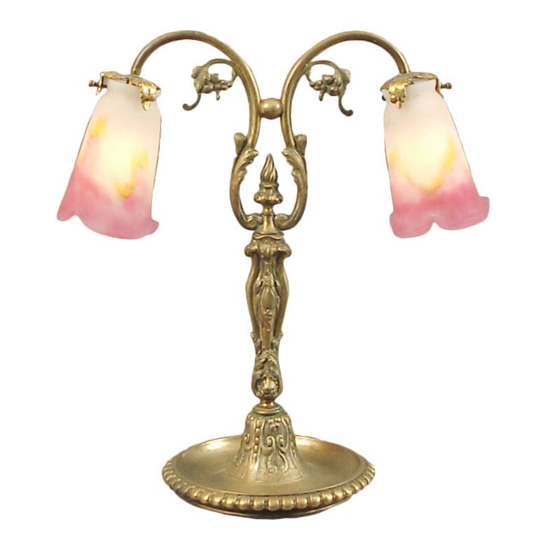 Here's a substantial, generously decorated solid brass or bronze table lamp, probably made Circa 1910.  Classic French design motifs adorn the base, and the signed pink, yellow and white Muller shades seem ideally suited to the antique bronze