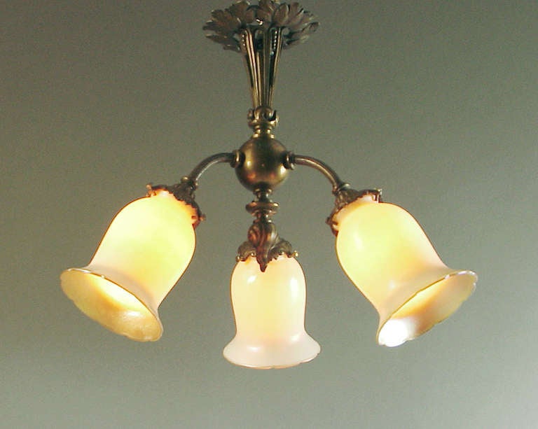 Here's a handsome 1910-ish Art Nouveau influenced French light fixture with -- gasp!! -- American art glass shades by Lustre Art.  A beautiful lamp for setting a restful, quiet mood.  All the fine qualities of French design and craftsmanship, all