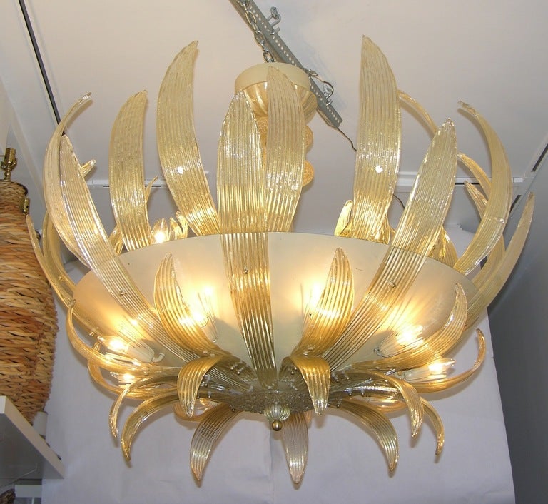 Commission-made Italian chandelier with 21 lights, the Murano glass by Seguso of the highest quality worked with pure gold and each piece individually hand crafted, the design unique and exceptional with a huge cream cold painted metal bowl embraced