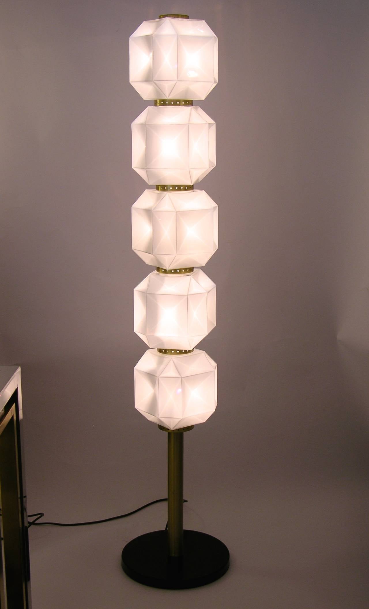 Unique floor lamp, made in Italy, with five diamond-shaped milk glass elements on a gilt brass stem supported by a black painted round metal base. Every piece is in white glass overlaid in clear, each individually blown within a mould, set one above