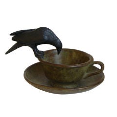 "Bird on a cup" whimsical bronze sculpture by Peter Woytuk