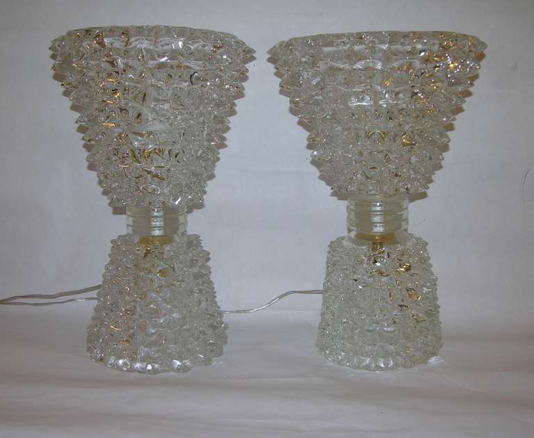 Exceptional pair of Murano glass lamps by Barovier, the blown crystal clear Murano glass worked with Rostrato, a technique to give a spiked design, this pair particularly special for the double lighting in the top part and also in the bottom part.