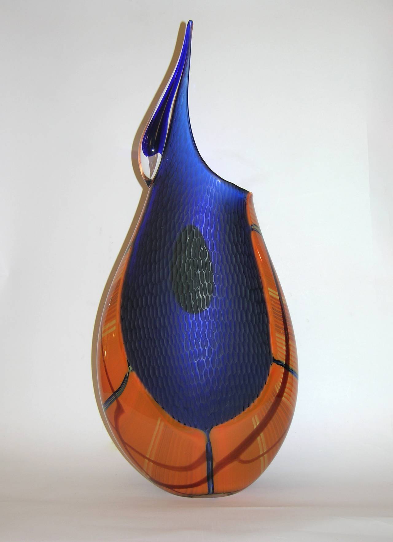 Contemporary work of art by Davide Dona' in blown Murano glass, this striking vase is beautifully overlaid in orange and blue and worked with a sophisticated enameled-like finish. The orange is decorated with elongated murrine and the blue sections