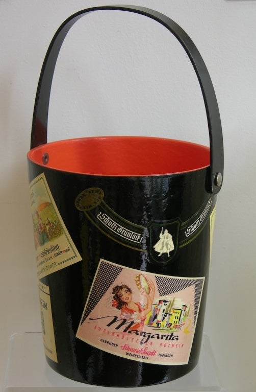 A delightful vintage item with high quality execution in lacquered papier ma^che´, vibrant red interior and black exterior ice bucket decorated with decoupage work of colorful wine labels. Great accessory to add character to your dining table, in