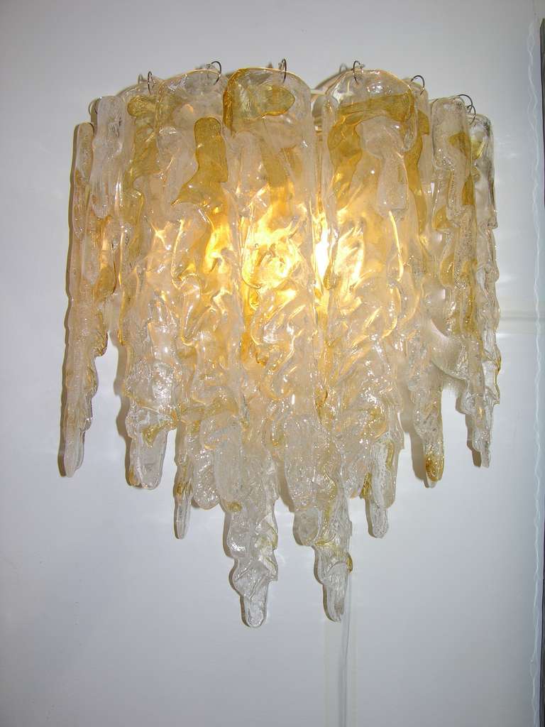 A striking pair of high quality wall lights by Mazzega, composed of individually mouth blown and handcrafted glass icicles in a sophisticated variegated Murano glass, decorated with amber streaks in the glass and worked with the Pulegoso technique: