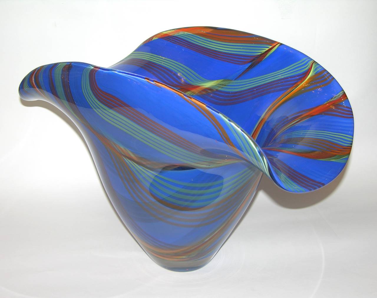 An extraordinary Work of Art in blown Murano glass by Davide Dona', this is a bowl/centerpiece really difficult to achieve for its grand blown size and for the decoration, with beautiful colored murrine, green, orange, red, yellow, in the blue body