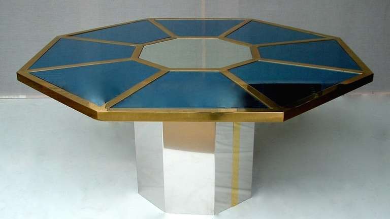 Finest craftsmanship for this rare Italian Design table by Romeo Rega, in an octagonal shape outlined with bronze edges and decorated around a central mirror with wedges of exceptional smoked blue glass, that really changes color under the light.