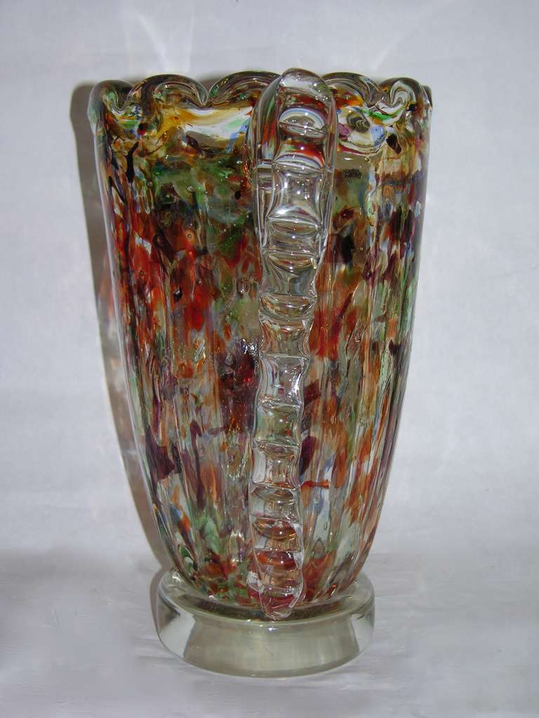 Striking colors for this blown Murano Glass vase worked with avventurina, in which copper metal micro crystals are dispersed in the translucent glass to reflect light, decorated with two clear glass shaped handles applied to the wavy bodies with