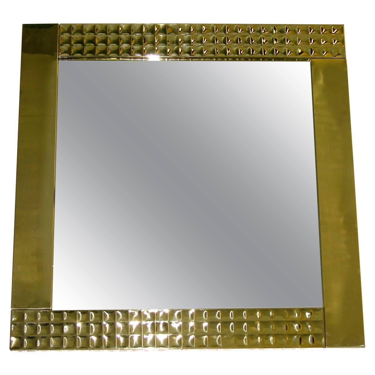 A very decorative pair of Italian mirrors handcrafted with a squared brass frame, decorated in a precious hammered pattern on two opposite sides that creates diamond like reflections. Can be displayed either way.
Two are available.