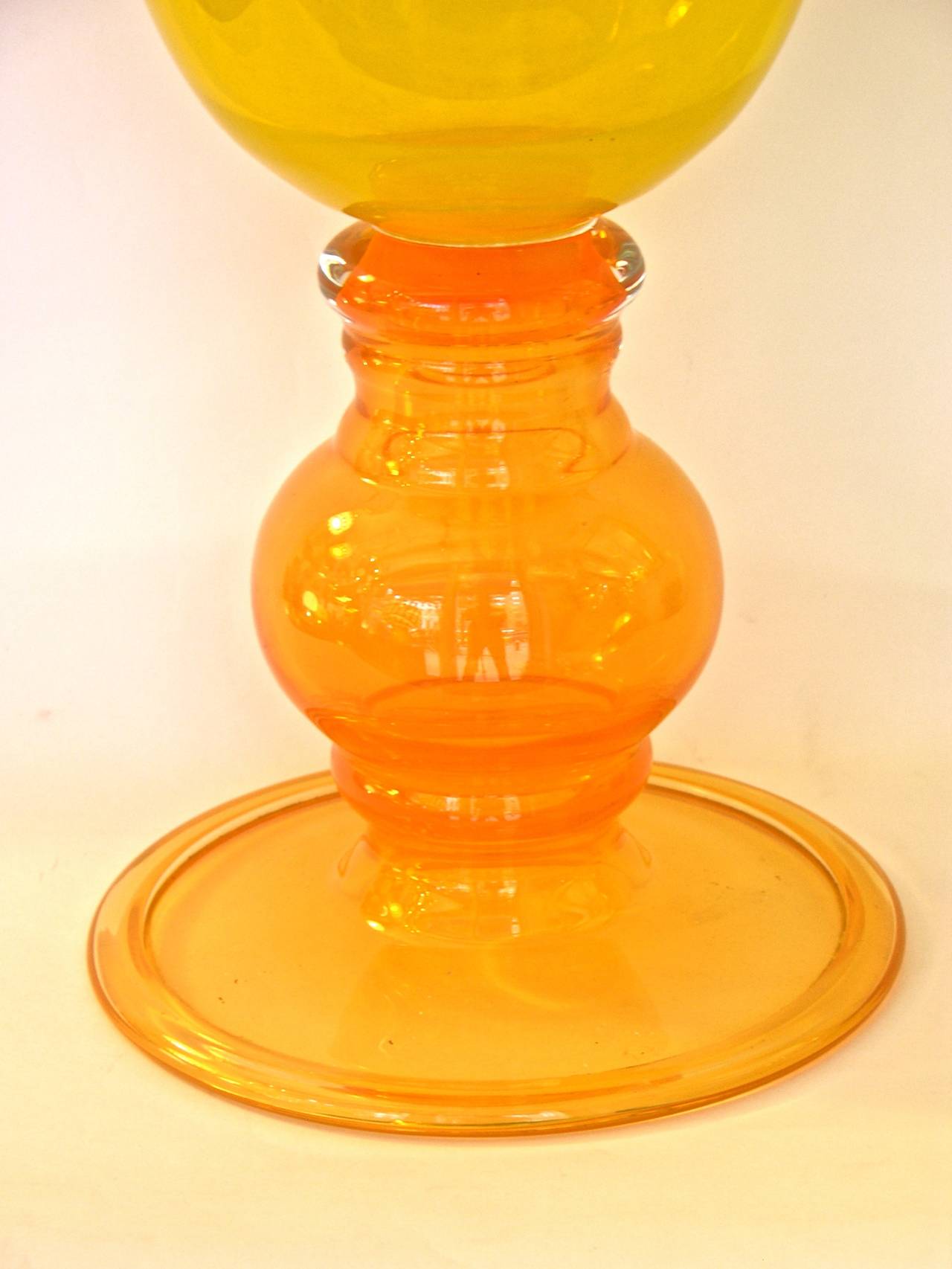 A striking Art Glass piece with the highest quality of execution, with exceptional blown turned borders, the yellow flared central body on a refined bulb base in blown orange Murano glass.