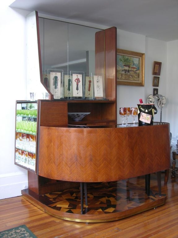 Italian bar, completely handcrafted in walnut and with Venetian glass mirrors and black glass top. This unique creation made on commission has an extraordinary design in every detail, for the genial use of space in a very compact and extremely