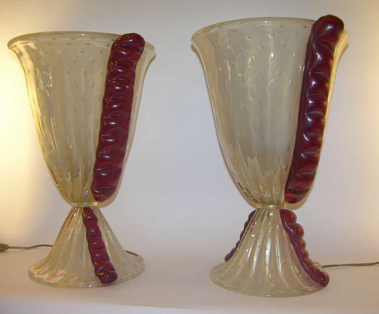 An Italian pair of exceptional 1970s Barovier e Toso lamps, the flared ribbed bodies in blown overlaid frosted Murano glass have an iridescence that gives a chic pearlized effect; they are worked for additional texture and glow with gold speckles