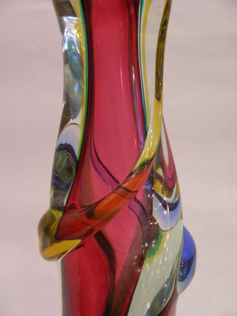 A vintage Mid-Century Modern Work of Art in Murano glass worked with the technique Sommerso: perfect layers of glass in different colors. This vase in an organic sculpture form shows a special quality in the brightness of the colors and the