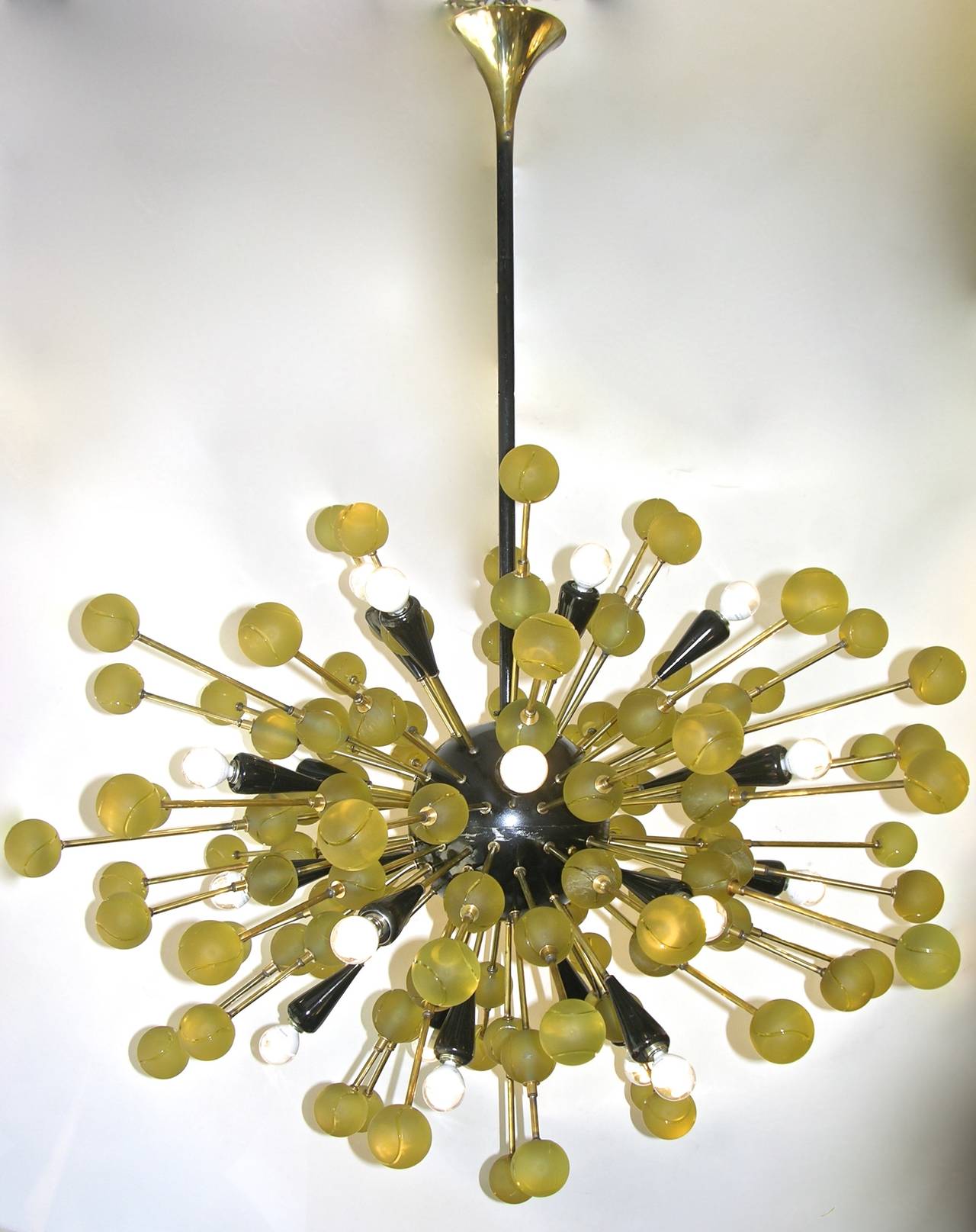 1980s unique Italian organic and very fun chandelier, entirely handcrafted, bronze rods decorated with high quality yellow solid Murano glass spheres, etched with swirls that make them resemble to tennis balls, jutting out of a central black painted