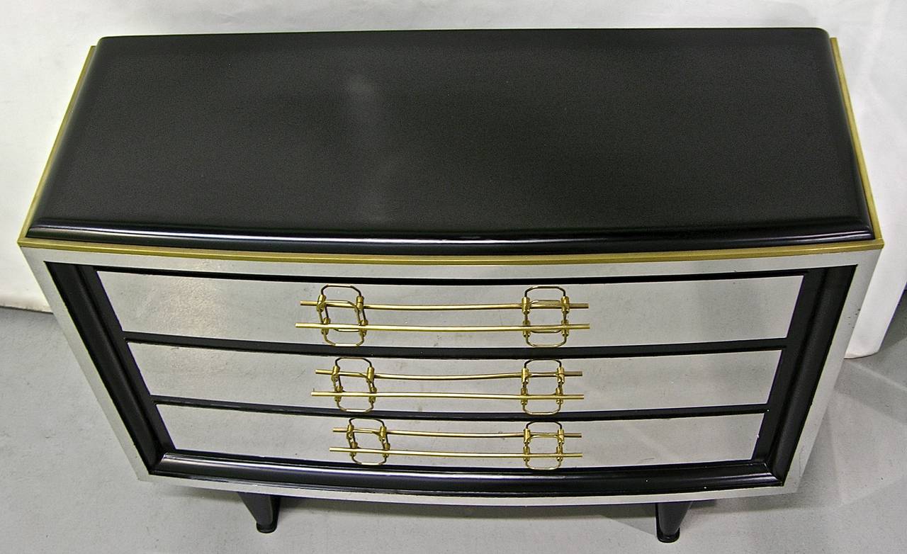 1970s very chic Italian chest with three drawers, entirely handmade with high quality construction and design. The wooden top is so smoothly lacquered that it seems finished in black leather. The surround is covered in chrome with a bronze edge, the