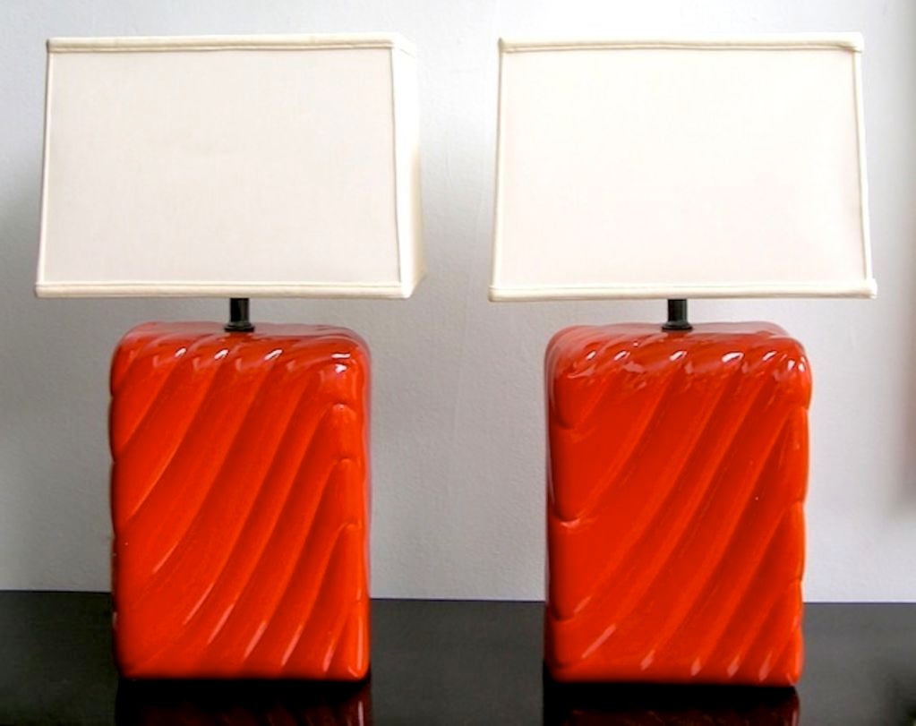 1960s Italian pair of lamps, handcrafted in ceramic, high quality of enamel-like glaze in a sexy orange, the bodies with curved lines. Sold without shades.