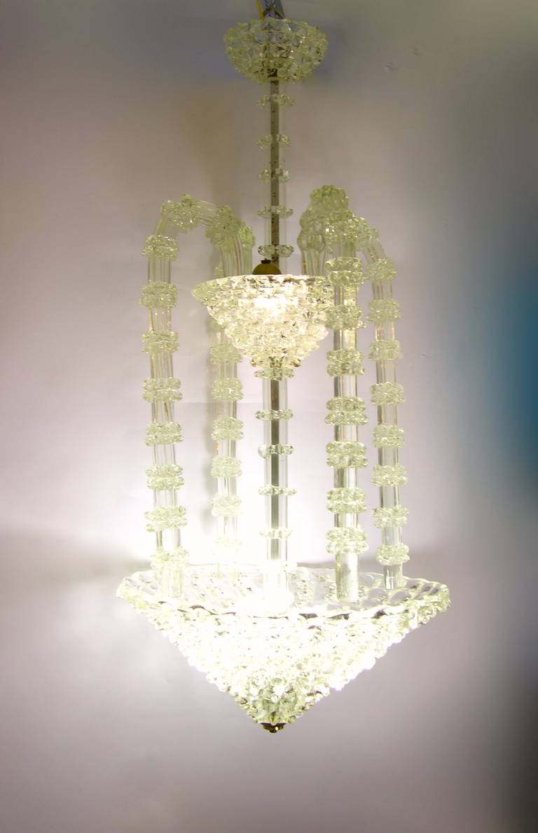 A very elegant Italian chandelier by Ercole Barovier presented at the biennale di Venezia in 1938. The mouth blown Murano glass bears a crystal quality, the execution is superior, using the technique called rostrato with hand crafted jutting