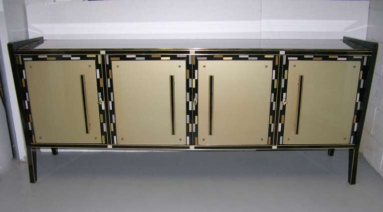 Very chic 1940 Italian cabinet with very distinctive colors, the front in a warm golden shade and the top and sides in a pearly beige with old rose hues, never seen before. All the design is accentuated with black and gold lines and a checkered