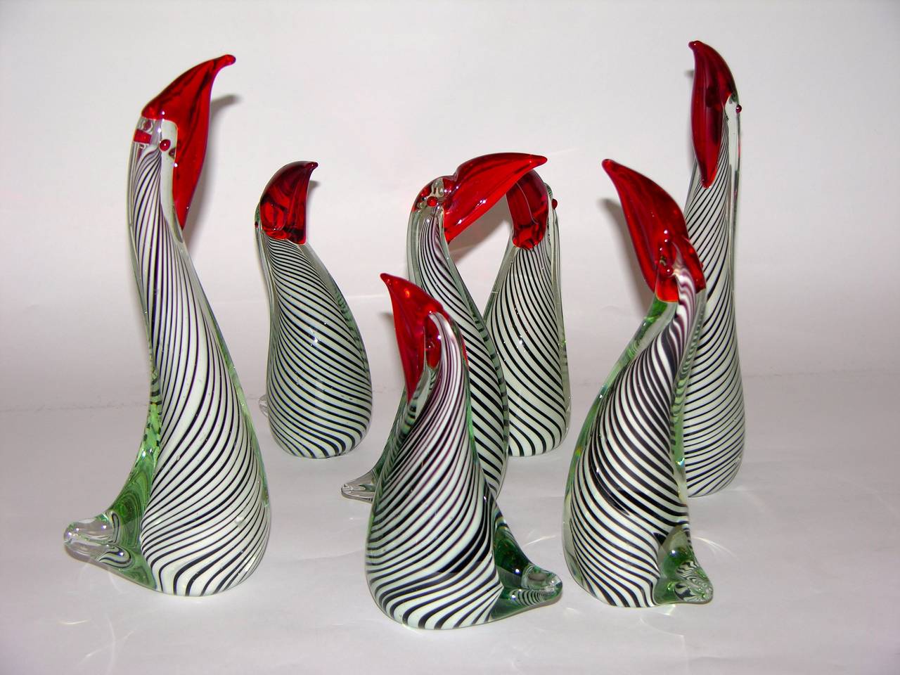 A fun group of six toucan birds with royal red beaks in mouth blown overlaid Murano glass, the bodies worked with the technique: a canne, in white and black overlaid in clear glass, each bird is individually crafted and different from the others.