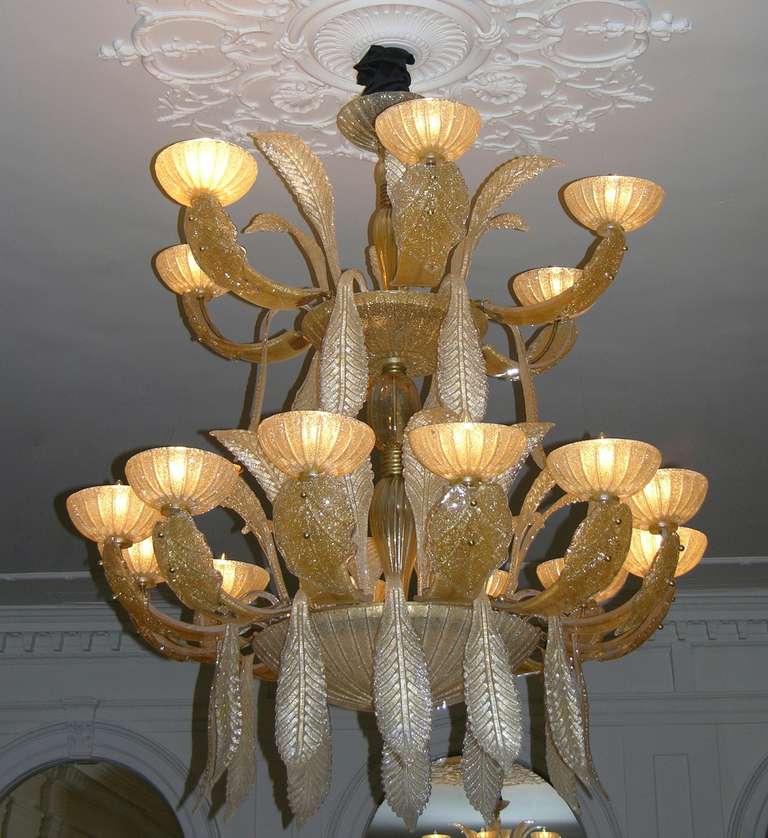 An exceptional two-tier Italian chandelier with 18 lights and plummeting leaves by Aureliano Toso, in Murano glass, every piece individually blown and handcrafted, the glass in two amber tones worked with granulato: Crushed glass blasted on reverse.