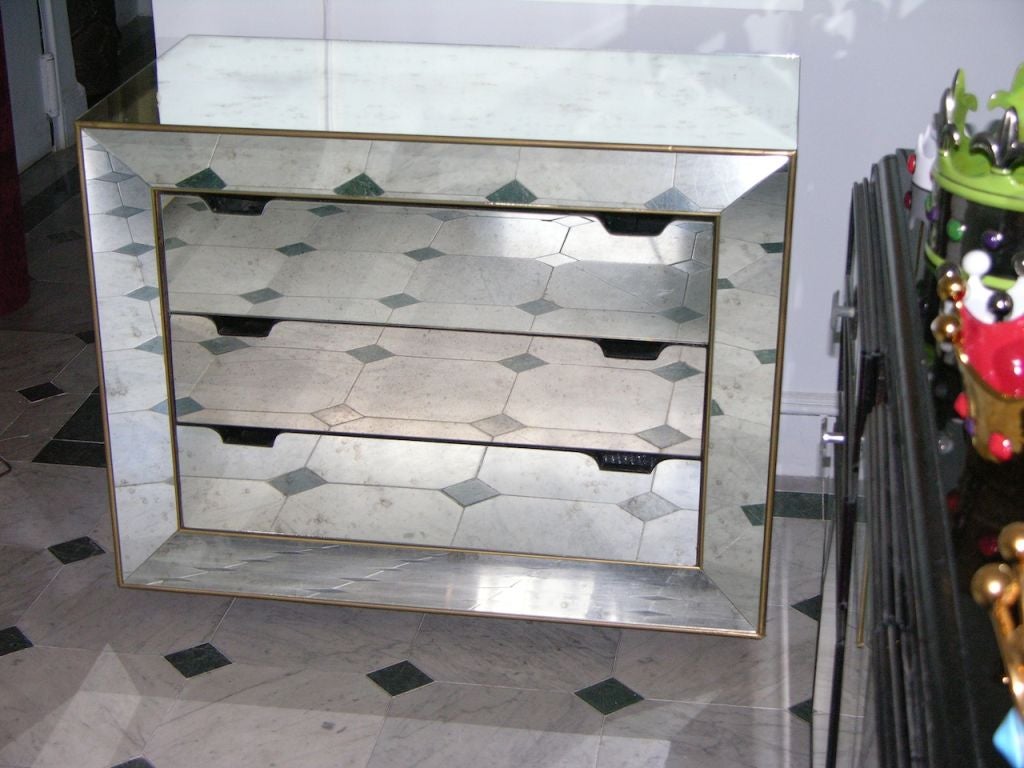Pair of Italian vintage mirrored chests in Venetian Murano glass, high quality of the design, different from the usual for the bronze-edged receding frame around the 3 drawers with no protruding handles, with black interior, raised on wood bun feet.
